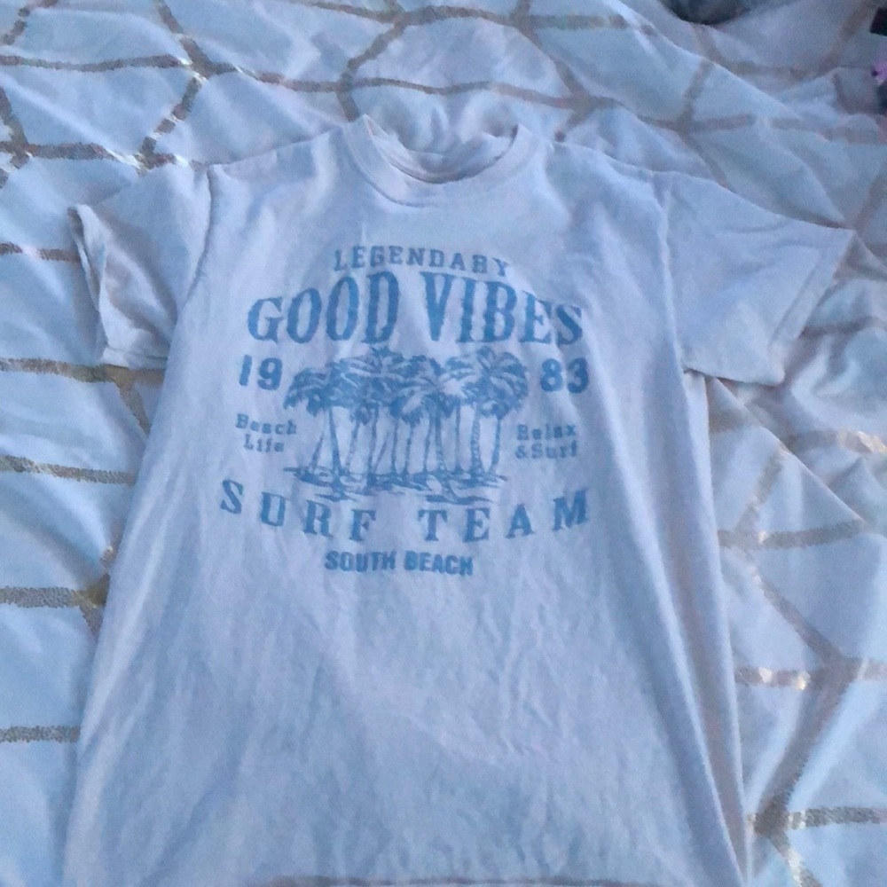 tan t-shirt with blue writing